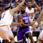 Sacramento Kings guard Tyreke Evans (32) drives between Phoenix Suns forward Jared Dudley (3) and forward TJ Warren (12) during the first half of an NBA basketball game, Wednesday, March 15, 2017, in Phoenix. (AP Photo/Matt York)