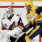Arizona Coyotes goalie Mike Smith (41) and Nashville Predators center Colton Sissons watch the rebound after Smith blocked a shot during the third period of an NHL hockey game Monday, March 20, 2017, in Nashville, Tenn. The Predators won 3-1. (AP Photo/Mark Humphrey)