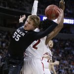 Xavier guard J.P. Macura (55) vies for a rebound against Arizona guard Kobi Simmons during the first half of an NCAA Tournament college basketball regional semifinal game Thursday, March 23, 2017, in San Jose, Calif. (AP Photo/Tony Avelar)