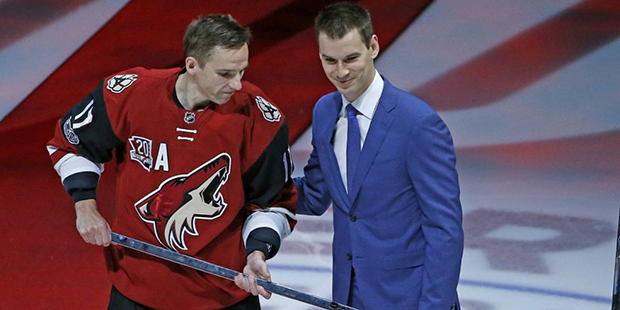 Arizona Coyotes right wing Radim Vrbata, left, receives a silver stick from Coyotes general manager...