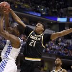 Kentucky's Bam Adebayo, left, heads to the basket as Wichita State's Darral Willis Jr. (21) defends during the first half of a second-round game in the men's NCAA college basketball tournament Sunday, March 19, 2017, in Indianapolis. (AP Photo/Jeff Roberson)