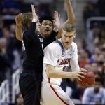Arizona forward Lauri Markkanen, right ,is defended by Xavier guard J.P. Macura, left, during the first half of an NCAA Tournament college basketball regional semifinal game Thursday, March 23, 2017, in San Jose, Calif. (AP Photo/Tony Avelar)