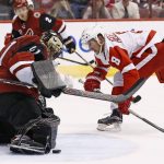 Arizona Coyotes goalie Mike Smith, left, makes a save on a shot by Detroit Red Wings left wing Justin Abdelkader (8) during the second period of an NHL hockey game Thursday, March 16, 2017, in Glendale, Ariz. (AP Photo/Ross D. Franklin)