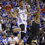 Kentucky guard Malik Monk (5) makes a pass around Wichita State forward Rashard Kelly (0) during the second half of a second-round game in the men's NCAA college basketball tournament in Indianapolis, Sunday, March 19, 2017. Kentucky defeated Wichita State 65-62. (AP Photo/Michael Conroy)