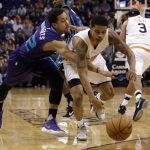 Charlotte Hornets guard Brian Roberts (22) and Phoenix Suns guard Tyler Ulis battle for a loose ball in the first quarter during an NBA basketball game, Thursday, March 2, 2017, in Phoenix. (AP Photo/Rick Scuteri)