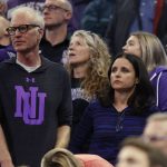 Actress Julia Louis-Dreyfus, lower right, and her husband, producer and writer Brad Hall, left, watch Northwestern play Vanderbilt during a first-round game of the NCAA men's college basketball tournament Thursday, March 16, 2017, in Salt Lake City. Northwestern won 68-66. (AP Photo/George Frey)