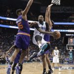 Charlotte Hornets' Michael Kidd-Gilchrist (14) drives past Phoenix Suns' Alan Williams (15) in the first half of an NBA basketball game in Charlotte, N.C., Sunday, March 26, 2017. (AP Photo/Chuck Burton)