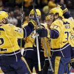 Nashville Predators' Mike Fisher (12) and Colin Wilson (33) celebrate with defenseman Ryan Ellis, second from right, after Ellis scored a goal against the Arizona Coyotes during the second period of an NHL hockey game Monday, March 20, 2017, in Nashville, Tenn. (AP Photo/Mark Humphrey)