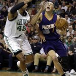 Phoenix Suns guard Devin Booker (1) drives against Boston Celtics center Al Horford (42) during the first quarter of an NBA basketball game, Friday, March 24, 2017, in Boston. (AP Photo/Elise Amendola)