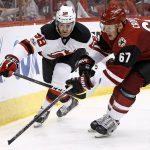 Arizona Coyotes left wing Lawson Crouse (67) and New Jersey Devils center Kevin Rooney (58) battle for the puck during the third period of an NHL hockey game Saturday, March 11, 2017, in Glendale, Ariz.  The Coyotes defeated the Devils 5-4. (AP Photo/Ross D. Franklin)