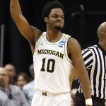 Michigan's Derrick Walton Jr. celebrates as the buzzer sounds at the end of a first-round game against Oklahoma State in the men's NCAA college basketball tournament Friday, March 17, 2017, in Indianapolis, Mo. Michigan won 92-91. (AP Photo/Jeff Roberson)