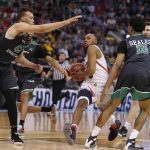 Arizona guard Parker Jackson-Cartwright (0) splits North Dakota forward Drick Bernstine (43) and guard Cortez Seales (15) on his way to the basket during the first half of a first-round game in the NCAA men's college basketball tournament Thursday, March 16, 2017, in Salt Lake City. (AP Photo/George Frey)