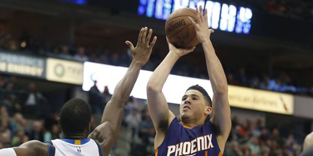 Phoenix Suns guard Devin Booker (1) shoots over Dallas Mavericks forward Harrison Barnes (40) durin...