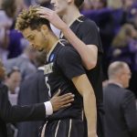 Vanderbilt's Luke Kornet, right, consoles guard Matthew Fisher-Davis (5) following the team's 68-66 loss to Northwestern in a first-round game of the NCAA men's college basketball tournament Thursday, March 16, 2017, in Salt Lake City. (AP Photo/Rick Bowmer)