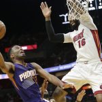 Phoenix Suns' TJ Warren (12) drives to the basket as Miami Heat's James Johnson (16) defends during the first half of an NBA basketball game, Tuesday, March 21, 2017, in Miami. (AP Photo/Lynne Sladky)