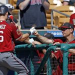 Arizona Diamondbacks shortstop Chris Owings (16) celebrates his home run against the Chicago White Sox with manager Torey Lovullo, right, during the second inning of a spring training baseball game Thursday, March 9, 2017, in Glendale, Ariz. (AP Photo/Ross D. Franklin)