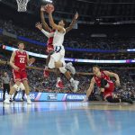 Villanova guard Josh Hart (3) drives to the basket against Wisconsin forward Ethan Happ (22), guard Khalil Iverson (21) and guard Zak Showalter (3) during the second half of a second-round game in the men's NCAA college basketball tournament, Saturday, March 18, 2017, in Buffalo, N.Y. Wisconsin won 65-62. (AP Photo/Bill Wippert)