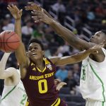 Oregon's Chris Boucher, right, fouls Arizona State's Tra Holder during the second half of an NCAA college basketball game in the quarterfinals of the Pac-12 men's tournament Thursday, March 9, 2017, in Las Vegas. Oregon won 80-57. (AP Photo/John Locher)