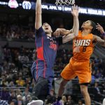 Detroit Pistons forward Jon Leuer (30) is fouled by Phoenix Suns guard Tyler Ulis (8) during the second half of an NBA basketball game in Auburn Hills, Mich., Sunday, March 19, 2017. (AP Photo/Paul Sancya)