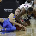 UCLA's Bryce Alford, left, and Arizona's Kadeem Allen scramble for the ball during the first half of an NCAA college basketball game in the semifinals of the Pac-12 men's tournament Friday, March 10, 2017, in Las Vegas. (AP Photo/John Locher)