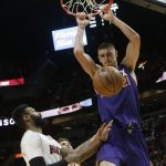 Phoenix Suns' Alex Len (21) dunks over Miami Heat's James Johnson during the first half of an NBA basketball game, Tuesday, March 21, 2017, in Miami. (AP Photo/Lynne Sladky)