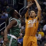 Phoenix Suns guard Devin Booker (1) shoots over Boston Celtics forward Jaylen Brown in the first quarter during an NBA basketball game, Sunday, March 5, 2017, in Phoenix. (AP Photo/Rick Scuteri)