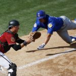 Arizona Diamondbacks catcher Matt Jones, left, waits for the throw as Chicago Cubs' John Andreoli dives for home plate during the seventh inning of a spring training baseball game Thursday, March 23, 2017, in Scottsdale, Ariz. The Cubs' Andreoli was out on the play, and the game ended in a 5-5 tie. (AP Photo/Ross D. Franklin)