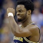 Michigan guard Derrick Walton Jr. (10) celebrates a 73-69 win over Louisville in a second-round game in the men's NCAA college basketball tournament in Indianapolis, Sunday, March 19, 2017. (AP Photo/Michael Conroy)