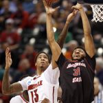 Jacksonville State's Christian Cunningham (31) and Louisville's Ray Spalding (13) reach for a rebound during the second half of a first-round game in the men's NCAA college basketball tournament Friday, March 17, 2017, in Indianapolis, Mo. Louisville won 78-63. (AP Photo/Jeff Roberson)