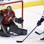 Arizona Coyotes goalie Mike Smith, left, reaches out to make a glove save in front of St. Louis Blues center Paul Stastny, right, during the first period of an NHL hockey game Saturday, March 18, 2017, in Glendale, Ariz. (AP Photo/Ross D. Franklin)