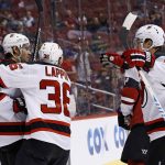 New Jersey Devils defenseman John Moore, left, celebrates his goal scored against the Arizona Coyotes with Nick Lappin (36) and Miles Wood, right, during the third period of an NHL hockey game Saturday, March 11, 2017, in Glendale, Ariz.  The Coyotes defeated the Devils 5-4. (AP Photo/Ross D. Franklin)