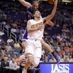 Phoenix Suns guard Devin Booker (1) slips past Sacramento Kings center Kosta Koufos during the second half of an NBA basketball game, Wednesday, March 15, 2017, in Phoenix. (AP Photo/Matt York)