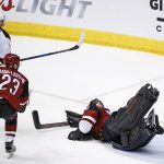 New Jersey Devils right wing Beau Bennett (8) beats Arizona Coyotes defenseman Oliver Ekman-Larsson (23) and goalie Mike Smith, right, for a goal during the second period of an NHL hockey game Saturday, March 11, 2017, in Glendale, Ariz. (AP Photo/Ross D. Franklin)