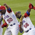 Dominican Republic pitcher Hector Neris (50) and pitcher Fernando Rodney (56) are introduced before a first-round game against Canada in the World Baseball Classic, Thursday, March 9, 2017, in Miami. (AP Photo/Lynne Sladky)