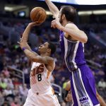 Phoenix Suns guard Tyler Ulis (8) shoots as Sacramento Kings center Kosta Koufos defends during the second half of an NBA basketball game, Wednesday, March 15, 2017, in Phoenix. (AP Photo/Matt York)
