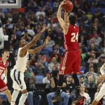 Wisconsin guard Bronson Koenig (24) takes a three-point shot against Villanova guard Mikal Bridges (25) during the second half of a second-round men's college basketball game in the NCAA Tournament, Saturday, March 18, 2017, in Buffalo, N.Y. Wisconsin won, 65-62. (AP Photo/Bill Wippert)