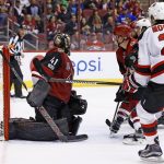 New Jersey Devils defenseman John Moore (2) scores a goal against Arizona Coyotes goalie Mike Smith (41) during the third period of an NHL hockey game Saturday, March 11, 2017, in Glendale, Ariz.  The Coyotes defeated the Devils 5-4. (AP Photo/Ross D. Franklin)