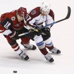 Arizona Coyotes center Christian Dvorak (18) and Colorado Avalanche left wing J.T. Compher (37) battle for the puck during the second period of an NHL hockey game Monday, March 13, 2017, in Glendale, Ariz. (AP Photo/Ross D. Franklin)