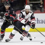 Carolina Hurricanes' Jordan Staal (11) and Arizona Coyotes' Alex Goligoski (33) chase the puck during the first period of an NHL hockey game in Raleigh, N.C., Friday, March 3, 2017. (AP Photo/Gerry Broome)
