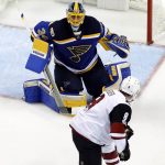 St. Louis Blues goalie Jake Allen, top, watches the puck as Arizona Coyotes' Tobias Rieder skates past during the second period of an NHL hockey game Monday, March 27, 2017, in St. Louis. (AP Photo/Jeff Roberson)