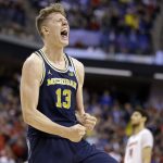 Michigan forward Moritz Wagner (13) celebrates a 73-69 win over Louisville in a second-round game in the men's NCAA college basketball tournament in Indianapolis, Sunday, March 19, 2017. (AP Photo/Michael Conroy)