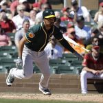 Oakland Athletics' Marcus Semien hits an RBI single during the second inning of a spring training baseball game against the Arizona Diamondbacks, Tuesday, March 7, 2017, in Scottsdale, Ariz. (AP Photo/Darron Cummings)