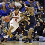 Louisville guard Quentin Snider (4) drives on Michigan guard Derrick Walton Jr. (10) during the second half of a second-round game in the men's NCAA college basketball tournament in Indianapolis, Sunday, March 19, 2017. Michigan defeated Louisville 73-69. (AP Photo/Michael Conroy)