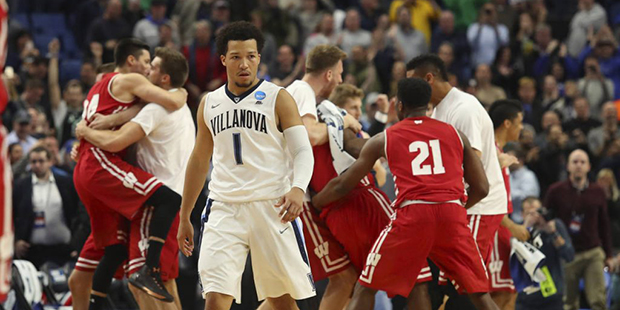 Villanova guard Jalen Brunson (1) leaves the court as Wisconsin players celebrate the end of their ...