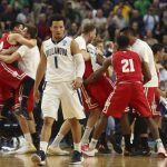 Villanova guard Jalen Brunson (1) leaves the court as Wisconsin players celebrate the end of their second-round game in the men's NCAA college basketball tournament, Saturday, March 18, 2017, in Buffalo, N.Y. Wisconsin won 65-62. (AP Photo/Bill Wippert)