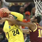 Oregon forward Dillon Brooks, left, goes to the basket against Iona guard Jon Severe, during the first half of a first-round game in the men's NCAA college basketball tournament in Sacramento, Calif., Friday, March 17, 2017. (AP Photo/Steve Yeater)