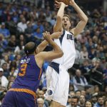 Dallas Mavericks forward Dirk Nowitzki (41) shoots over Phoenix Suns forward Jared Dudley (3) during the first half of an NBA basketball game in Dallas, Saturday, March 11, 2017. (AP Photo/Michael Ainsworth)