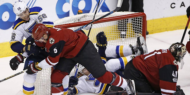 Arizona Coyotes defenseman Connor Murphy (5) battles with St. Louis Blues left wing Magnus Paajarvi...