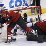 Arizona Coyotes defenseman Connor Murphy (5) battles with St. Louis Blues left wing Magnus Paajarvi (56) as Blues' center Ivan Barbashev flips over Coyotes goalie Mike Smith (41) during the first period of an NHL hockey game Saturday, March 18, 2017, in Glendale, Ariz. (AP Photo/Ross D. Franklin)