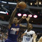 Phoenix Suns guard Eric Bledsoe (2) grabs a rebound in front of Dallas Mavericks forward Harrison Barnes (40) during the first half of an NBA basketball game in Dallas, Saturday, March 11, 2017. (AP Photo/Michael Ainsworth)